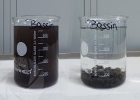 A clean, clear and colorless filtrate after treatment